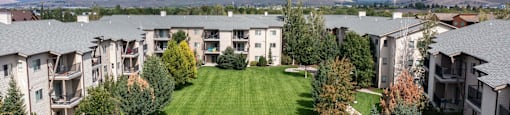 Aerial view of an apartment complex with a lawn and trees  at Mullan Reserve Apartments, Missoula, MT
