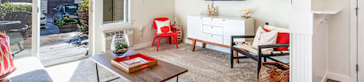 Living room with white walls and a sliding glass door that leads to a patio at Mullan Reserve Apartments in Missoula, MT