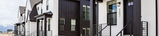 A row of modern houses with black and white exteriors.