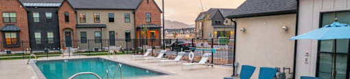 A hot tub sits in the middle of a patio with chairs around it.