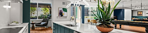 a kitchen with a large white counter top and green cabinets