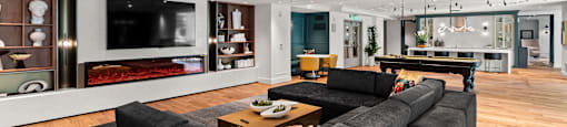 a living room with a large gray couch and a television