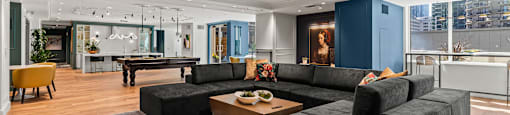 a large living room with couches and a pool table