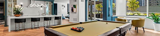 a game room with a pool table and a bar