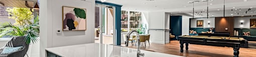 a kitchen with a large island and a pool table