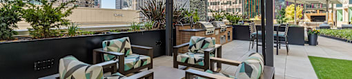 a terrace with chairs and tables and a view of the city