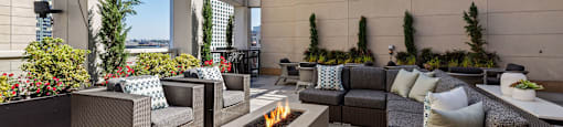 an outdoor patio with furniture and a fire pit