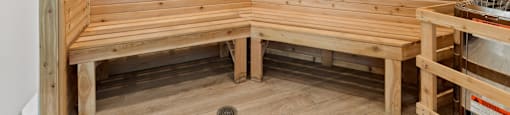 two benches in the corner of a wooden sauna