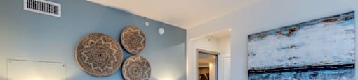 a bedroom with a bed and a painting on the wall