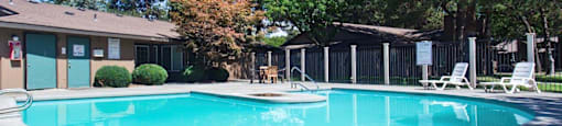 Arbropointe Apartments Pool with Lounge Chairs