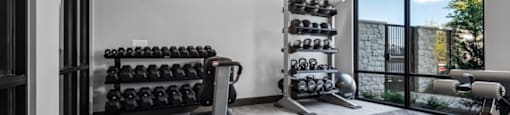 A well-equipped home gym with a variety of exercise equipment.