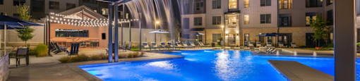 A large outdoor swimming pool with a slide at a resort.