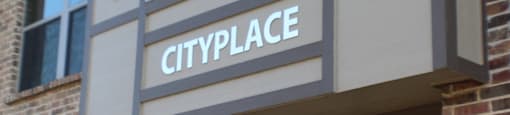 Property entrance sign with address number at City Place Apartments, Denton, Texas