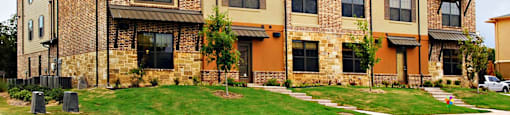 A large brick apartment building with multiple windows and balconies at Centre Place Apartments, Texas, 76205