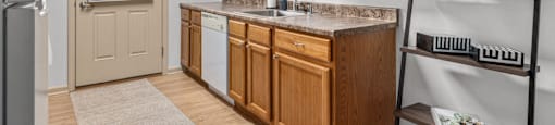 A kitchen with wooden cabinets and a white countertop.