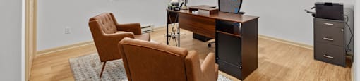A room with a desk, chairs, and pictures on the wall.
