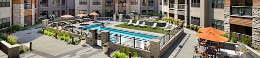 a large pool is in the middle of a building with apartments at Avenue C Apartments, Billings, MT