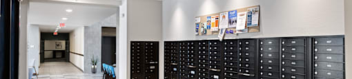 a long hallway with lockers and a table in the center at Avenue C Apartments, Montana