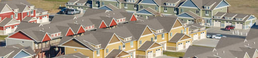 A suburban neighborhood with houses and cars.