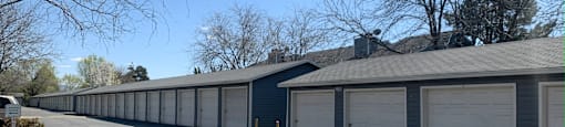 a row of garages with a blue sky in the background