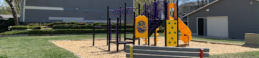a playground with a bench in front of it