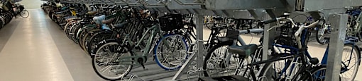 A bike rack with many bicycles parked on it.