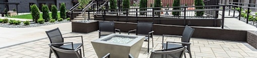 A patio with a table and chairs2 and a fountain.