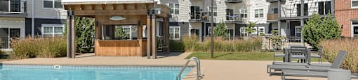 a swimming pool in front of an apartment building