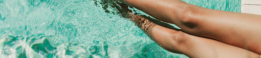 A person's legs are submerged in water.