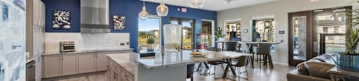 a kitchen with a center island and a dining table
