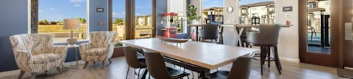 a dining room with a table and chairs