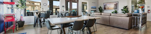 a living room and dining room with a table and chairs