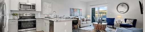 a spacious living room with a kitchen and a living room