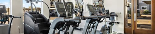 a gym with various exercise equipment on the floor