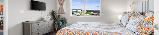 a bedroom with a bed and a window