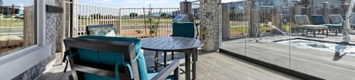 a patio with a table and chairs and a large window
