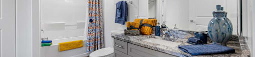 a bathroom with a large mirror and a toilet and a shower