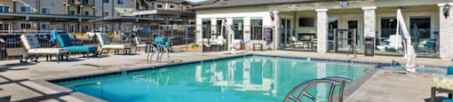 a swimming pool with a building in the background