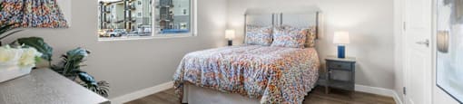 a bedroom with a bed and a ceiling fan