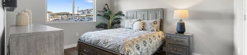 a bedroom with a bed and a window