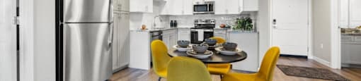 a kitchen and dining room with a table and chairs