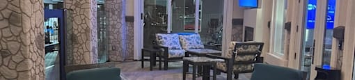 a large patio with chairs and tables and a tv