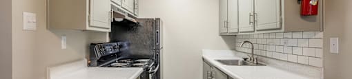 Galley Style Kitchen with Black Appliances