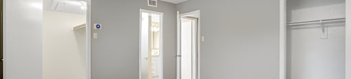 an empty living room with white walls and wood flooring