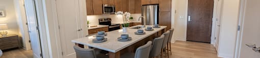 a kitchen and dining room with a table and chairs