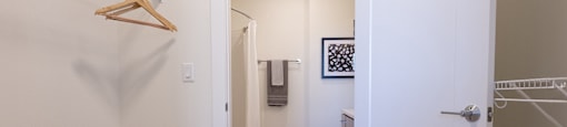 a hallway with a closet and a door to a bathroom