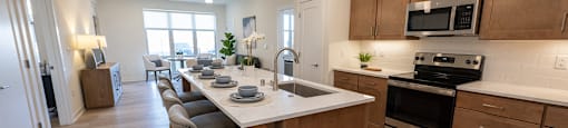 a kitchen with a large island and a table with chairs