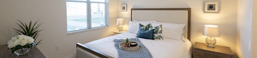 a bedroom with a large bed and a ceiling fan