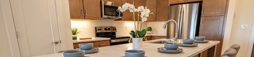 a kitchen with a marble table with plates and bowls on it
