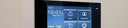 a touchscreen screen on a wall with icons on it